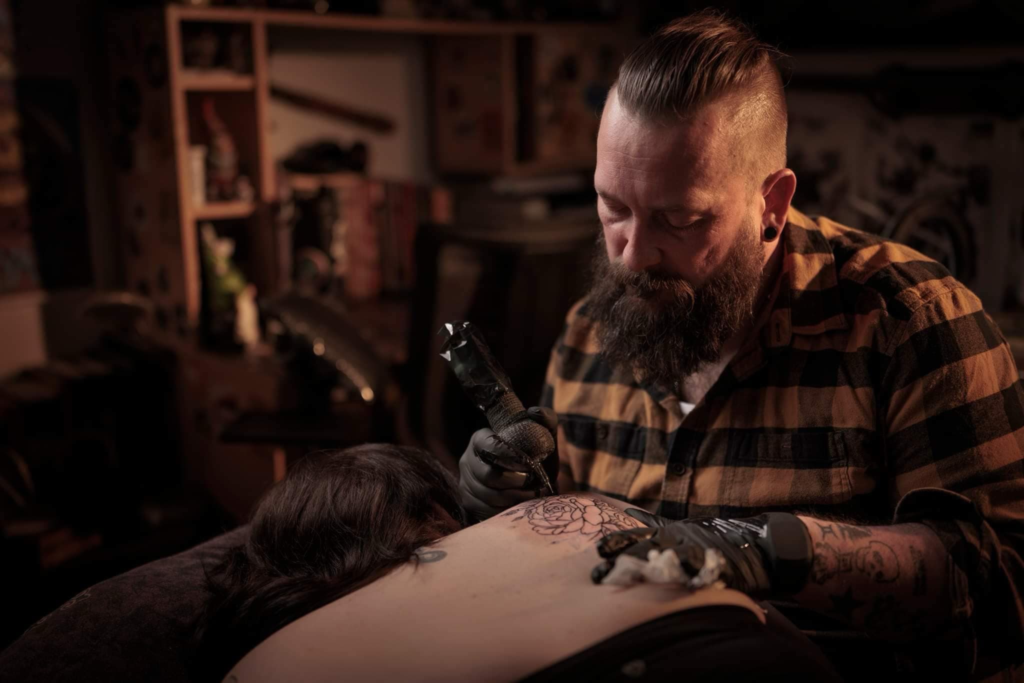 Jason Johnston working on a tattoo in his studio